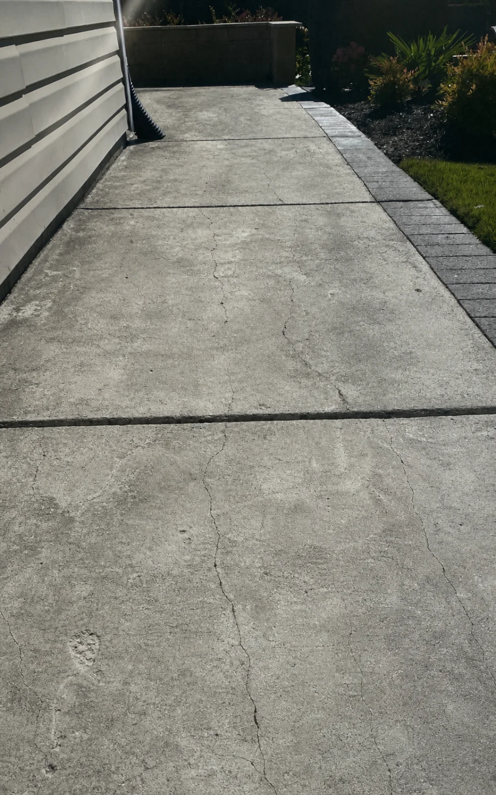 Cracked concrete walkway in Adelaide before resin-bound resurfacing